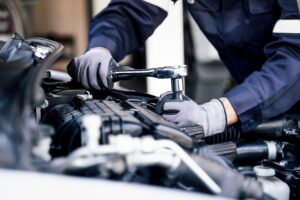 Professional mechanic working on the engine of a car